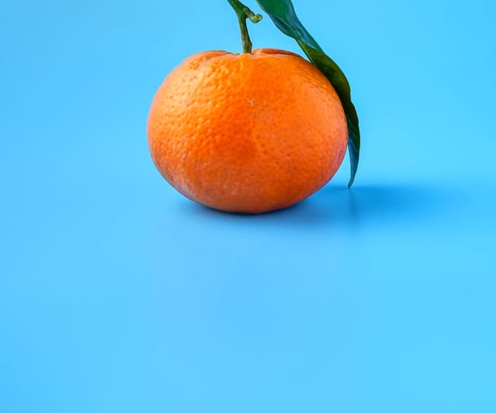 an orange with blue background